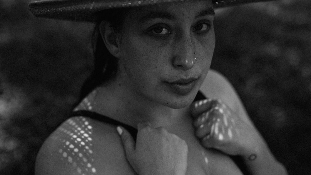 Atum's Influence: A Grayscale Photo of a Woman Wearing a Sun Hat