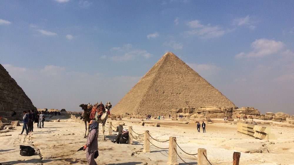 Exploring Ancient Egypt: Pyramid of Giza under a Blue and White Sky